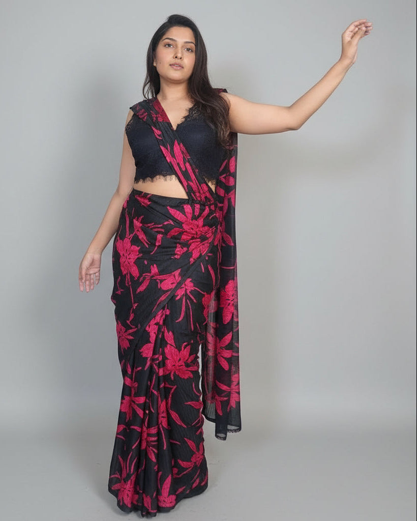 Woman wearing a black and red floral outfit standing indoors.