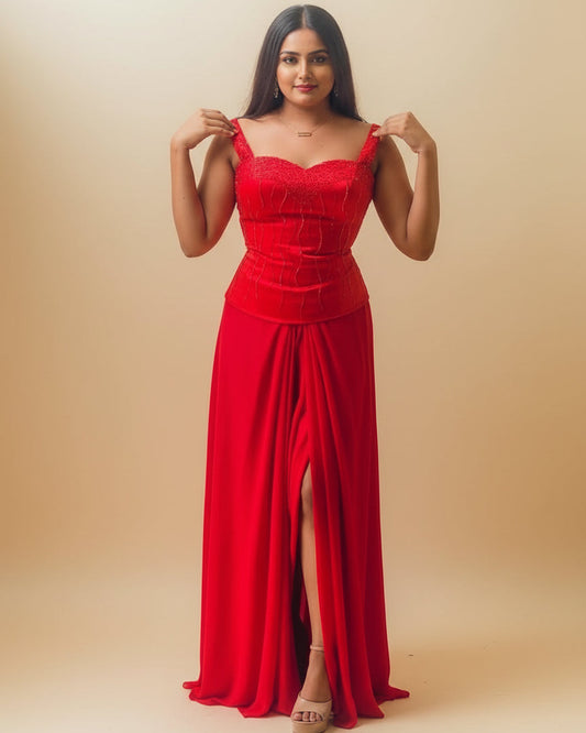 Woman wearing a red dress standing in a room with a light-colored wall.