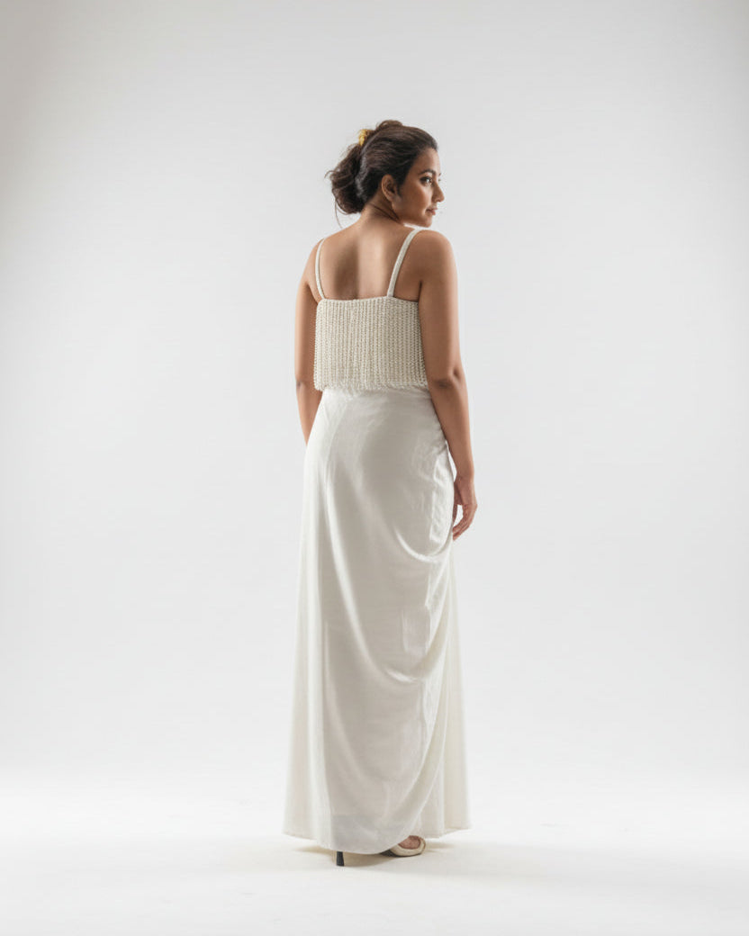 Woman wearing a white dress with a plain background