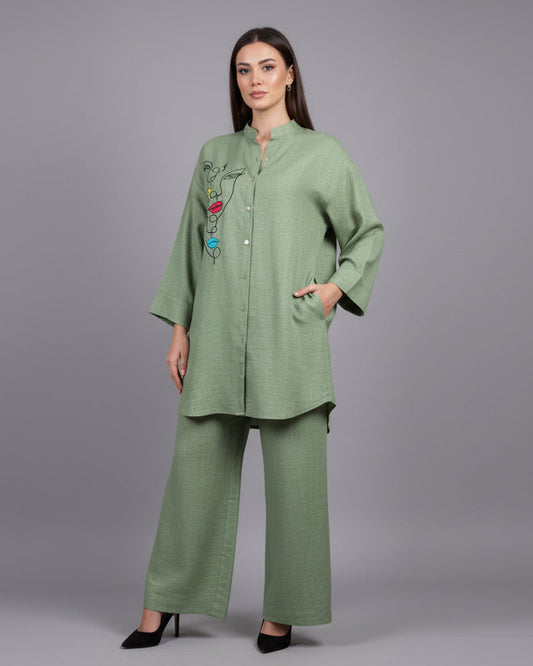 Green outfit on a mannequin against a white wall.