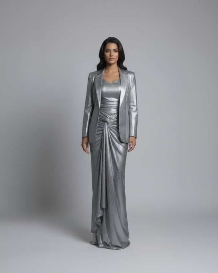Mannequin wearing a silver metallic outfit in a room with doors and tiled floor.