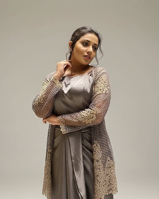 Woman in a gray dress with a textured brown wall background