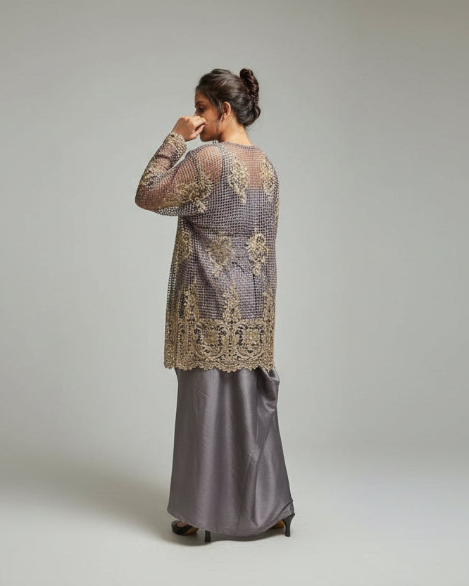 Woman standing in front of a textured wall with a railing