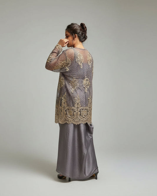 Woman standing in front of a textured wall with a railing