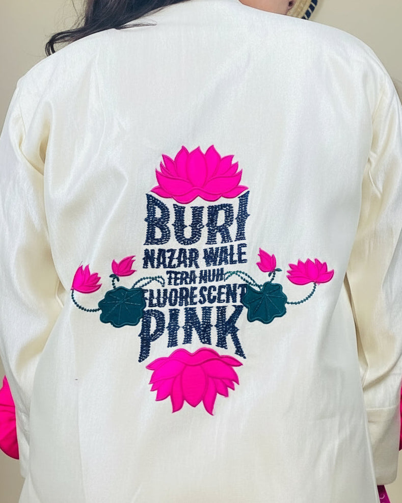 White garment with colorful text and floral designs on the back, worn by a person.